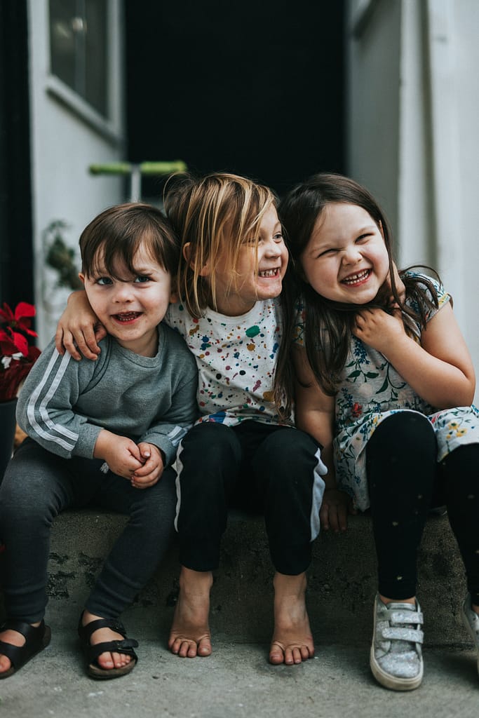 Kids sitting and smiling together